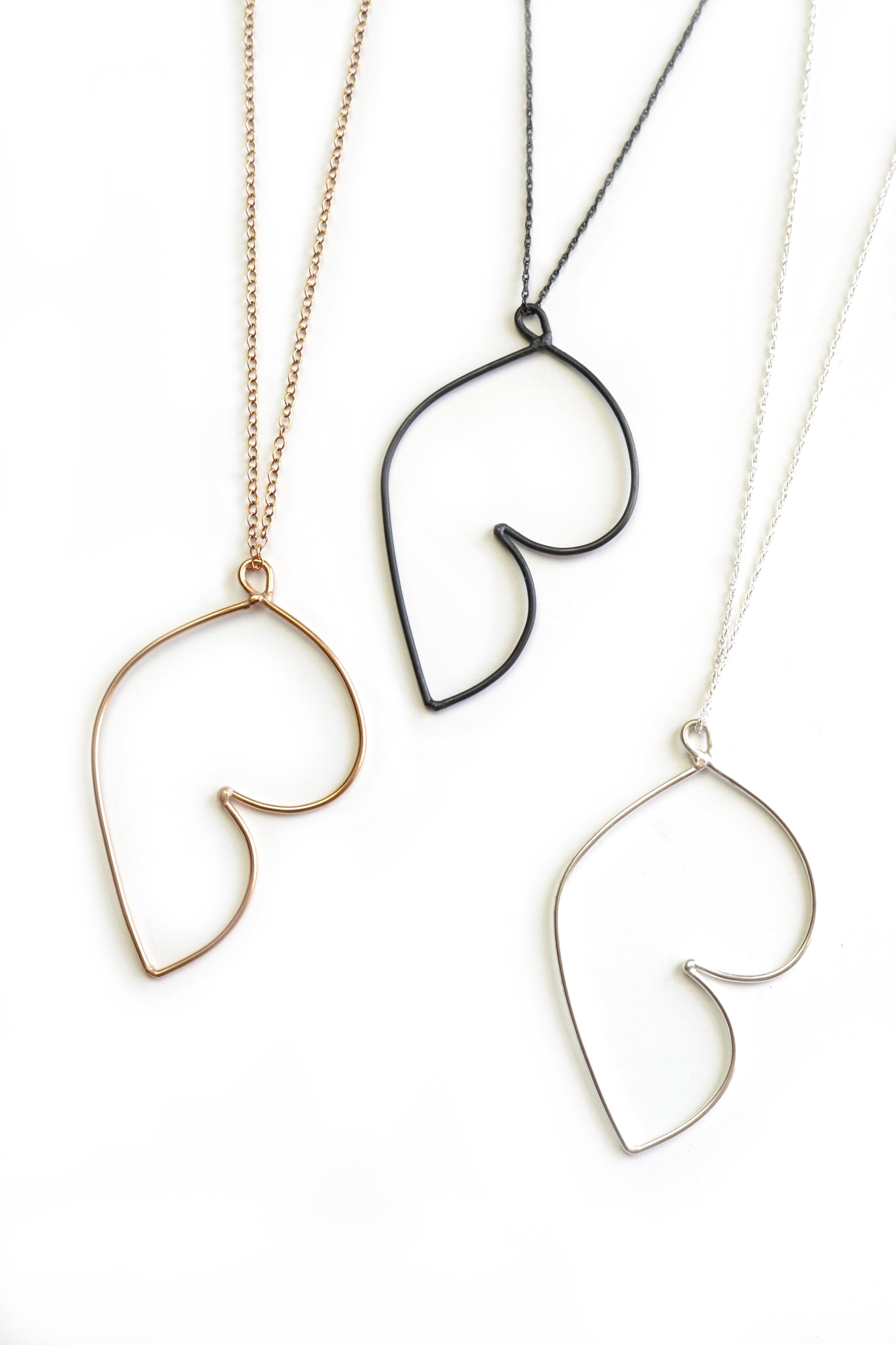 Matisse inspired jewelry - bronze, black, and silver pendants